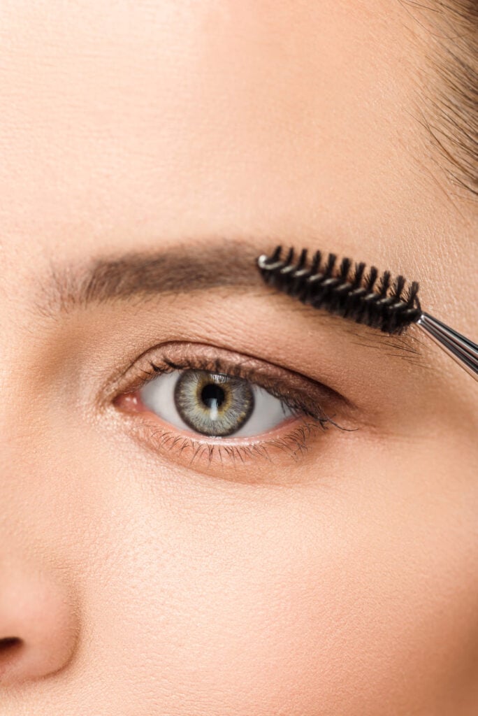 A close-up vertical shot focusing on a woman's eye and eyebrow.