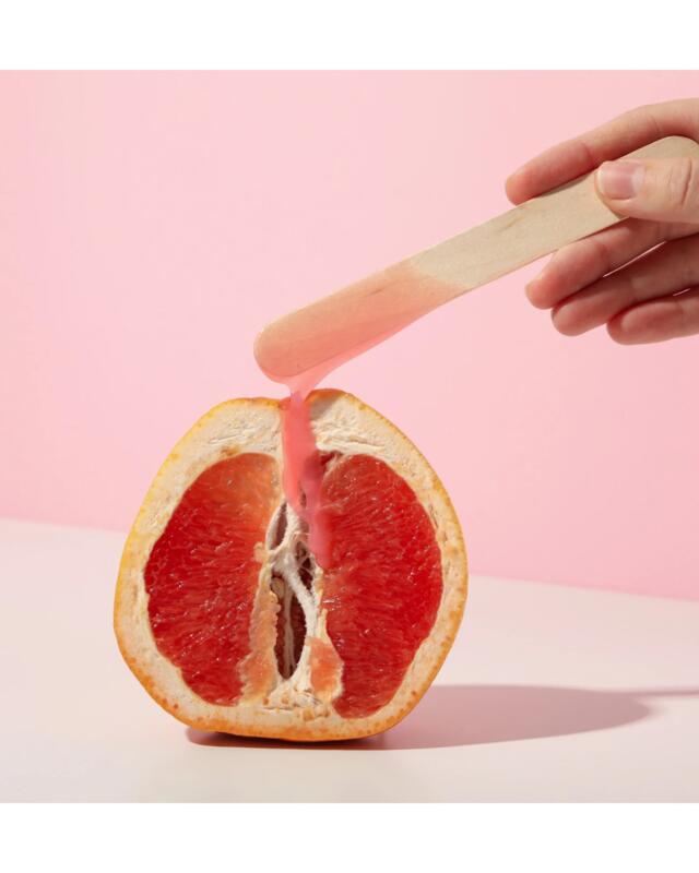 A halved pink grapefruit,