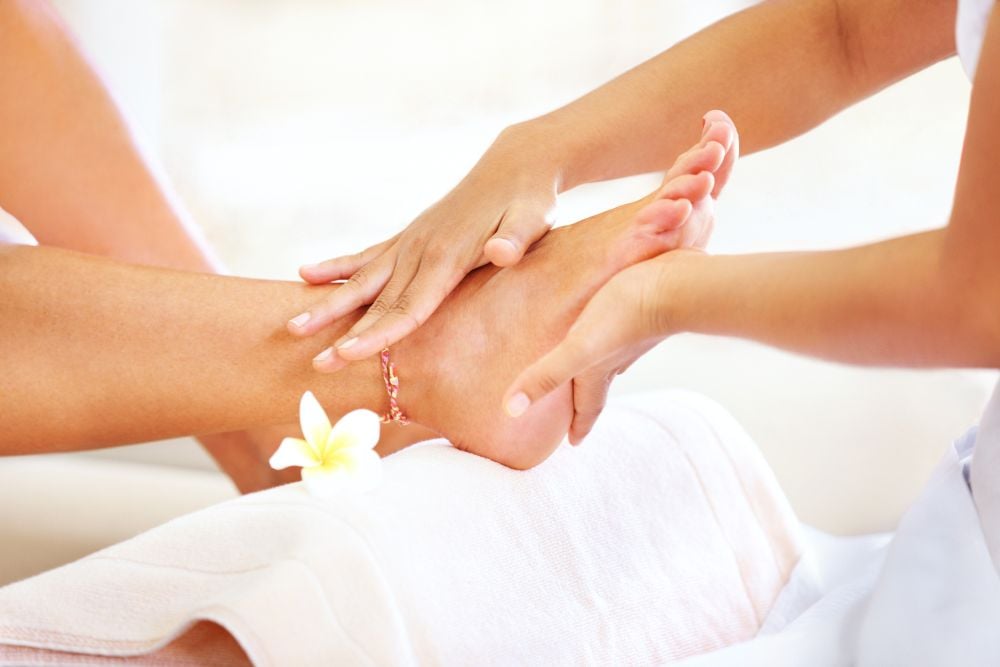 A client receiving a relaxing foot and ankle massage.