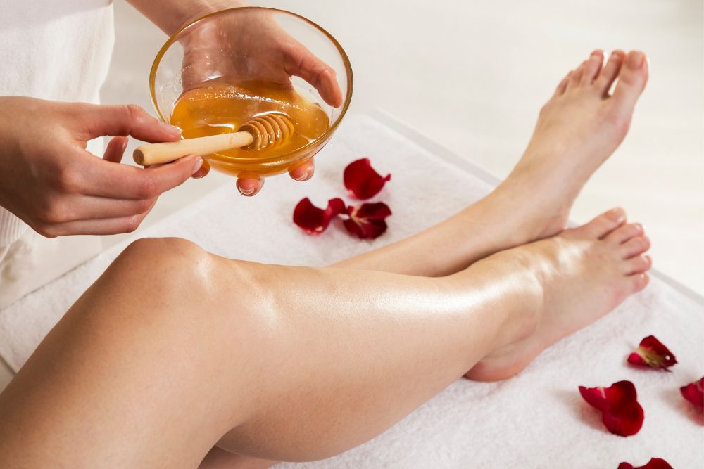A client's smooth, bare legs on a treatment bed, suggesting a hair removal service.